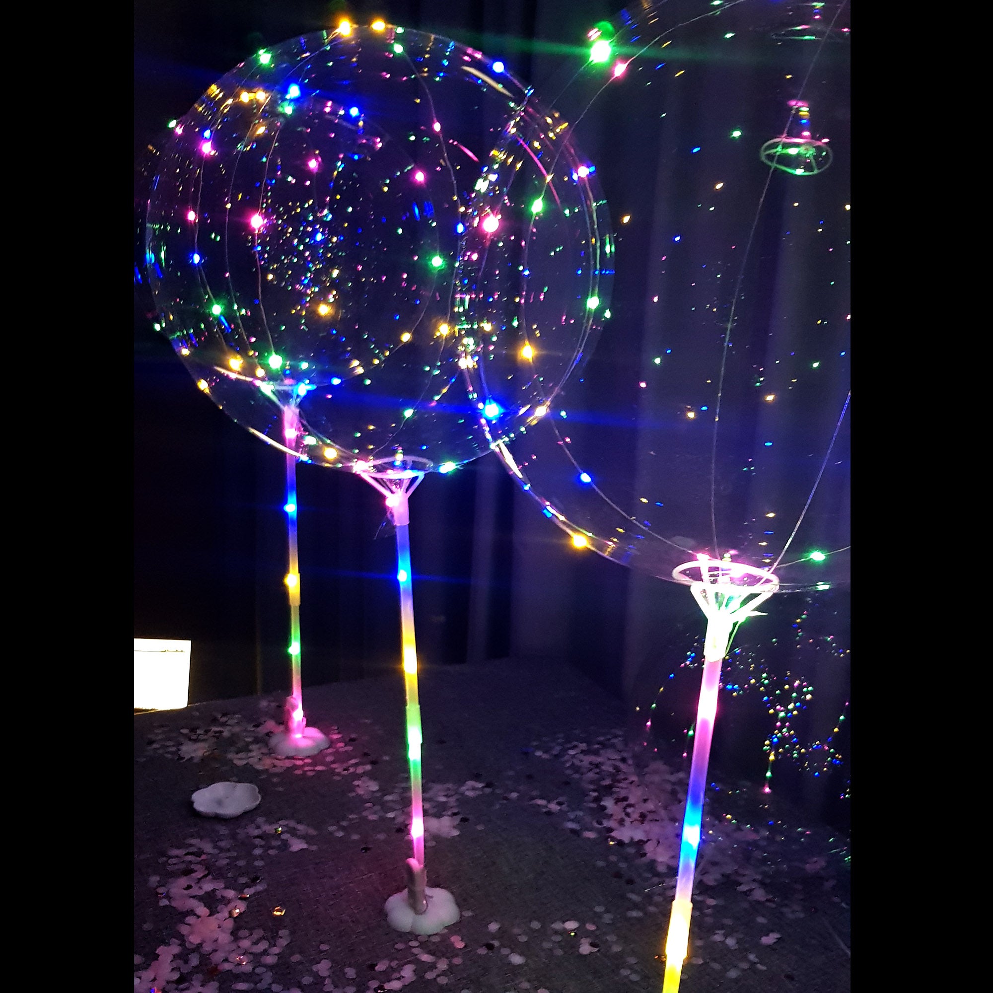 Lighted balloons on a shop stick